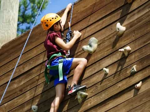 a girl climbing a fence