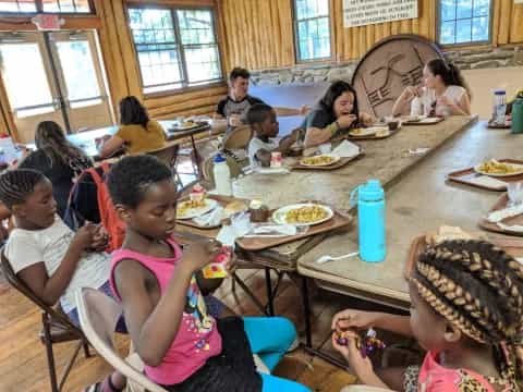 a group of kids eating at a table
