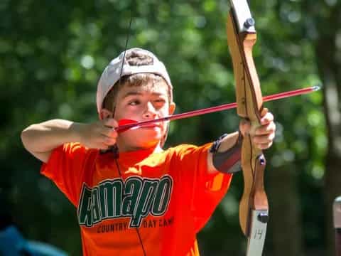 a boy holding a bow and arrow