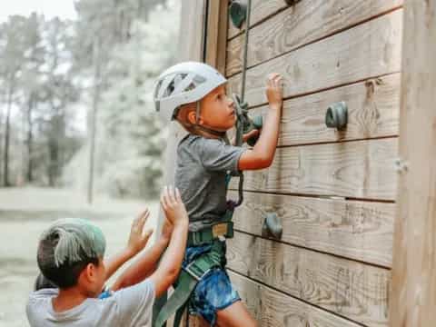 a boy climbing a fence