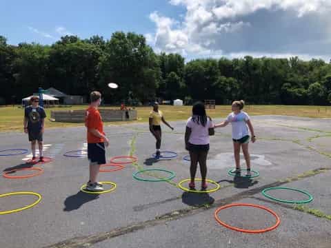 a group of people playing frisbee