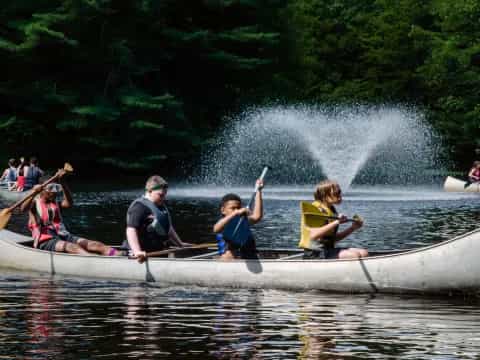 a group of people rowing a boat