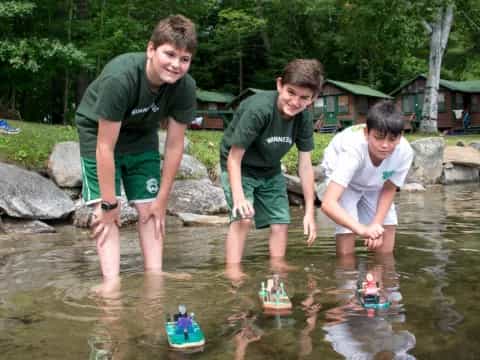 a group of boys playing in a pond