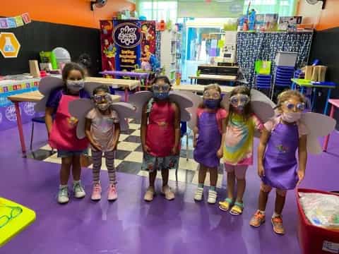 a group of kids wearing clothing