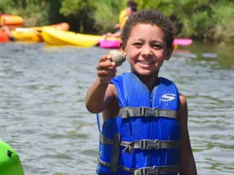 a boy holding a fish