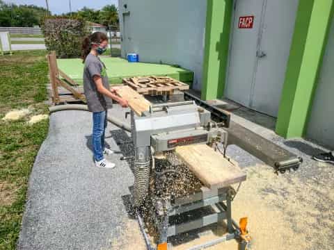 a man standing next to a machine