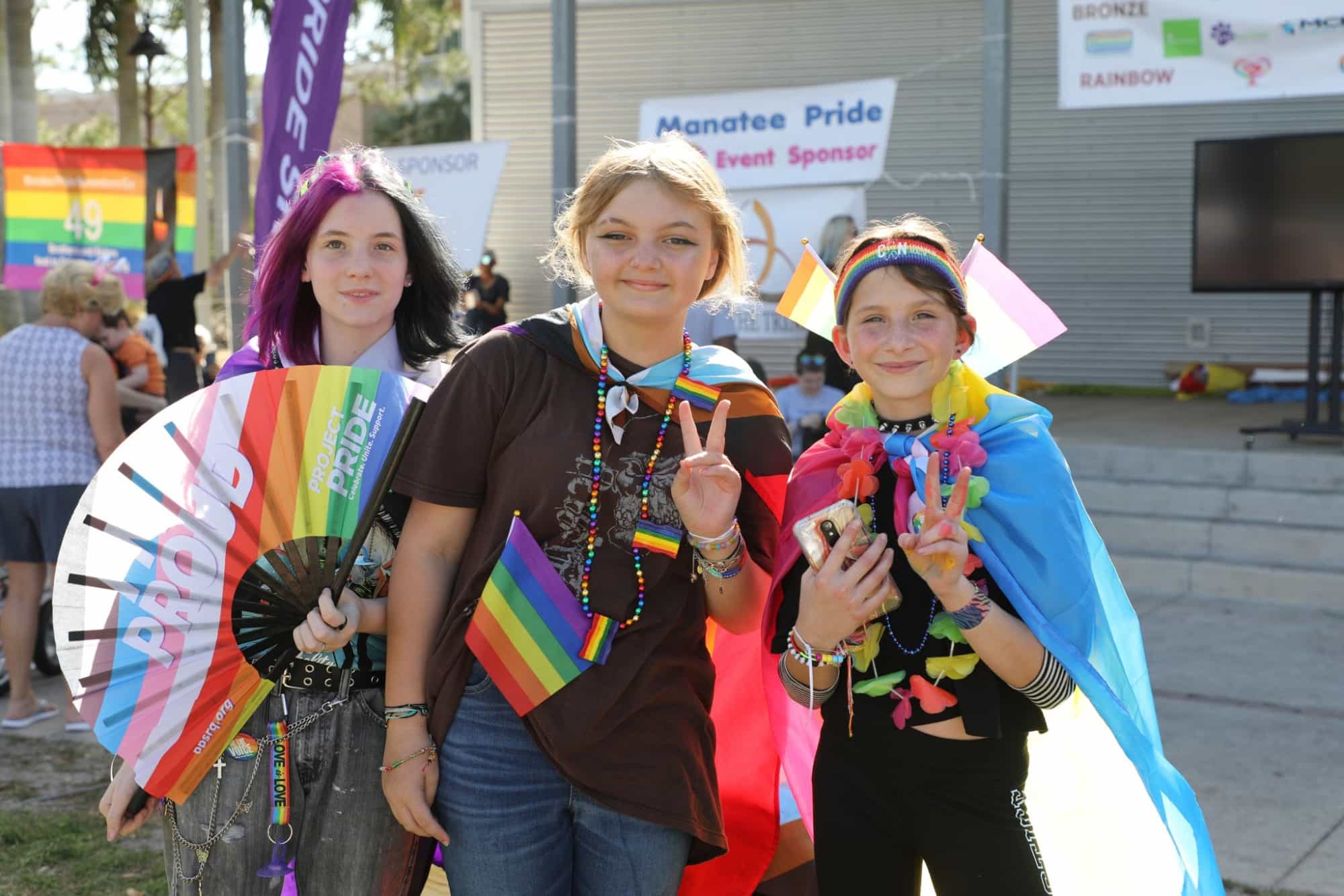 a group of women holding up a peace sign