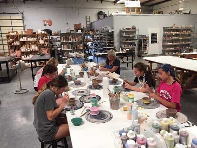 a group of people sitting at a table eating food