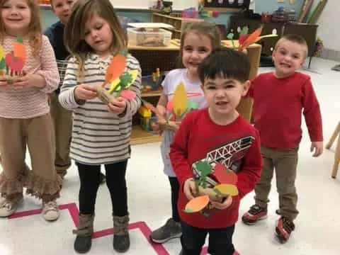 a group of children holding toys