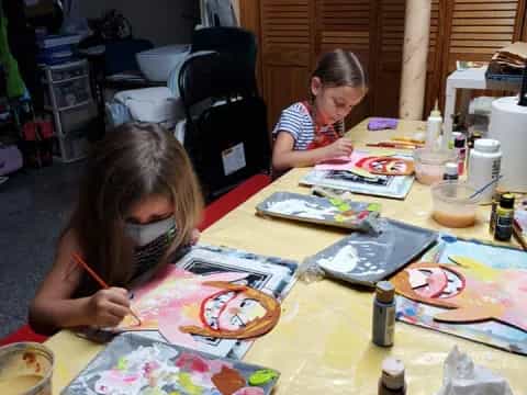 a couple of young girls painting