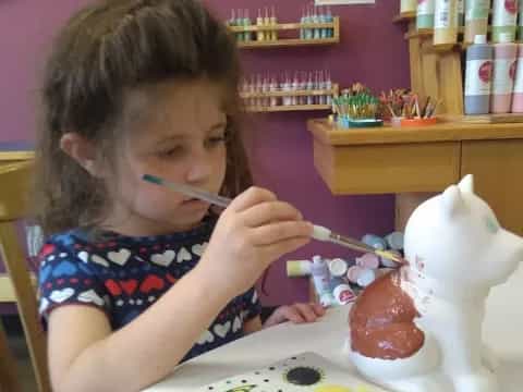a little girl eating a cupcake