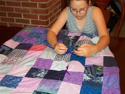 a girl sitting on a bed