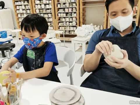 a couple of boys wearing masks