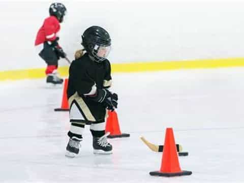a young girl playing ice hockey