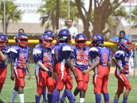 a group of kids in football gear
