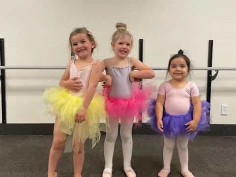 a group of girls in dresses