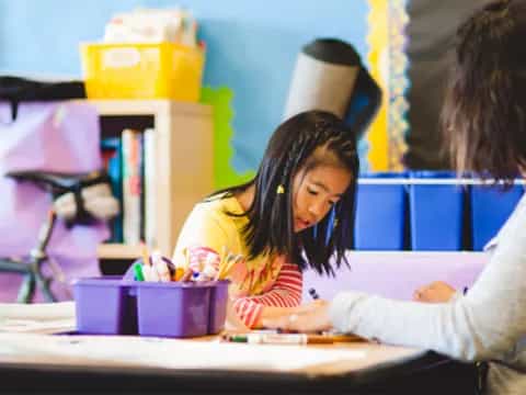 a person and a child studying