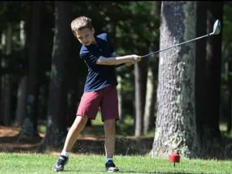 a boy swinging a bow and arrow