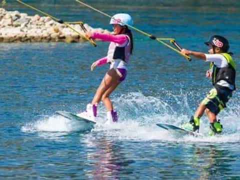 a couple of people water skiing