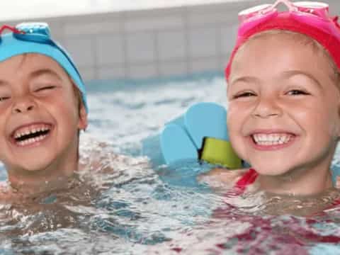 a couple of children in a pool