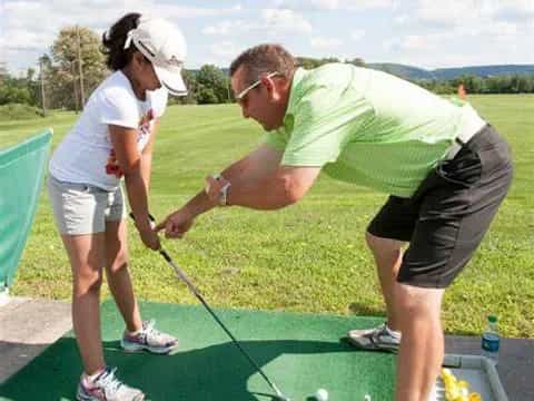 a man and a woman playing golf