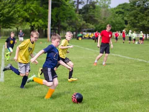 a group of kids playing football