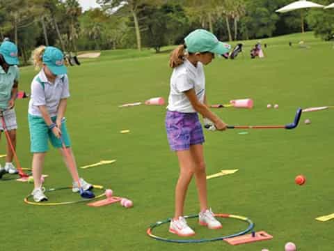 a group of people playing golf