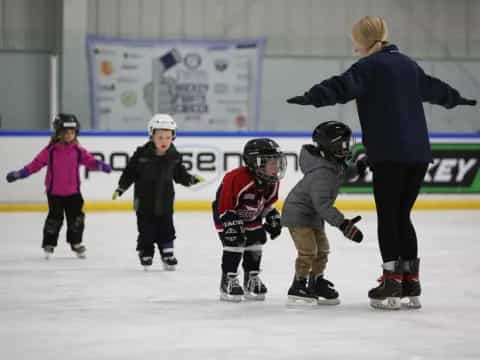 a person and kids on ice skates