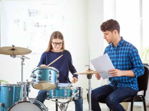 a man and a woman playing drums