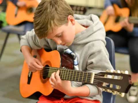 a boy playing a guitar