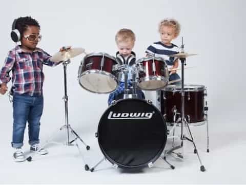 a group of kids playing drums