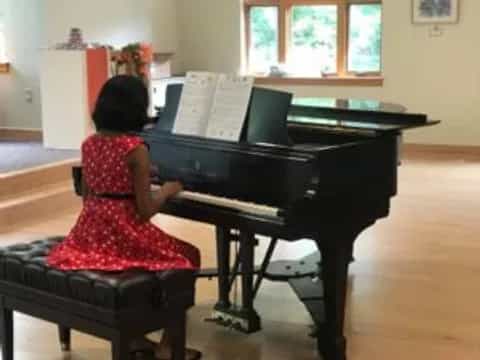 a girl playing a piano