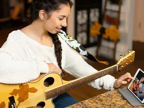 a woman playing a guitar