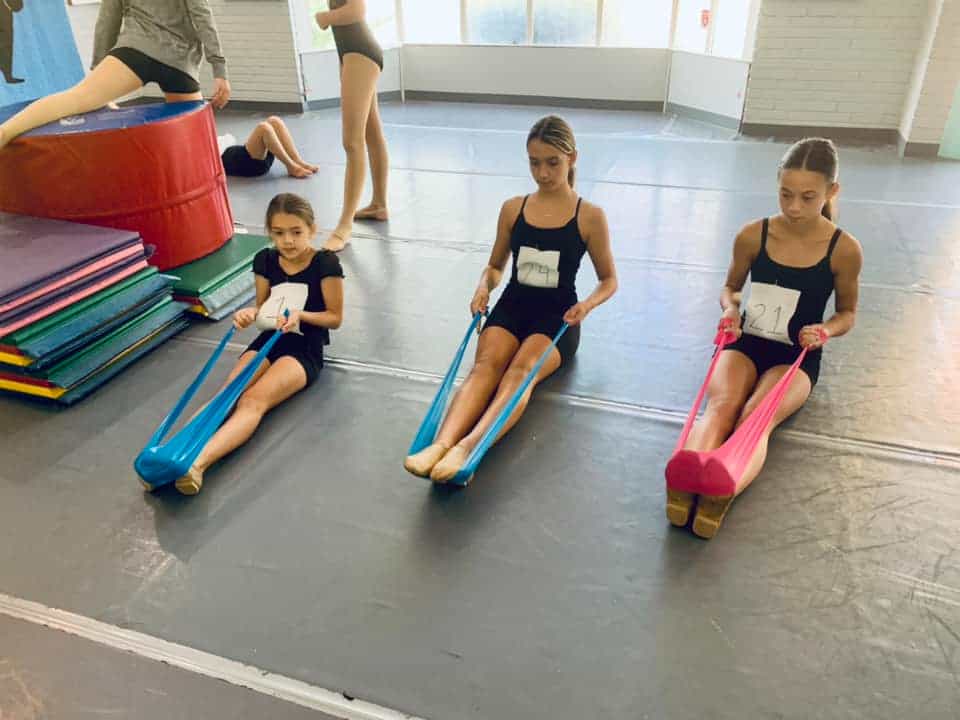 a group of kids sitting on mats