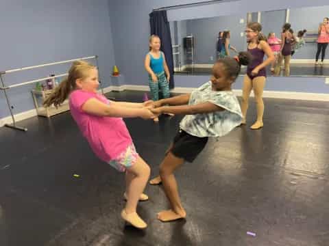 a couple of girls dancing