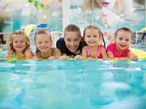 a group of children in a pool