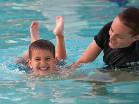 a man and a child in a pool