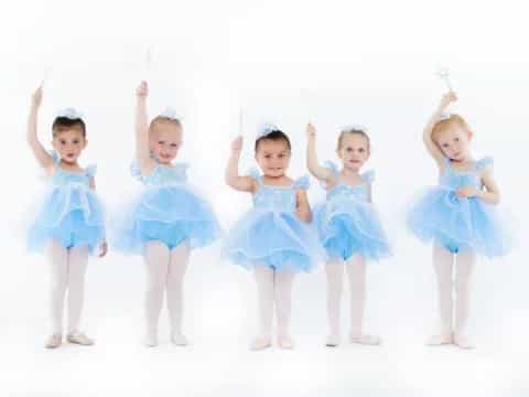 a group of girls in blue dresses