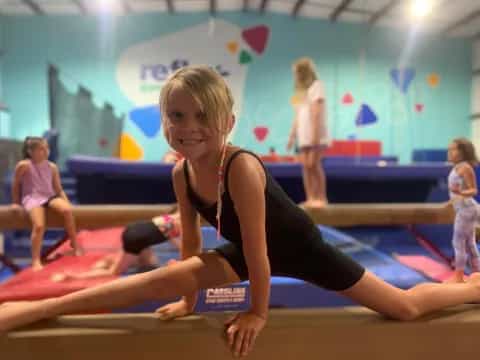 a woman in a leotard on a mat