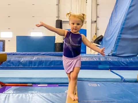 a girl jumping on a trampoline