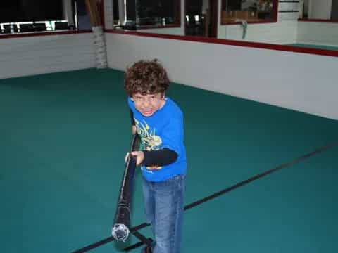 a boy holding a golf club