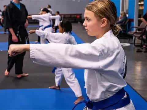 a girl in a karate uniform