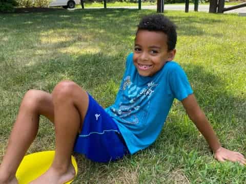 a boy lying on the grass