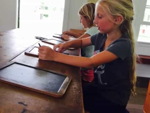 a young girl using a computer