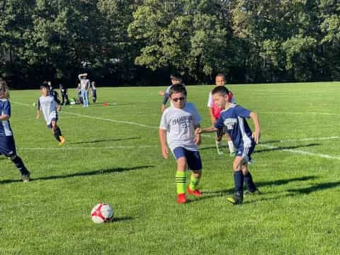 a group of kids playing football