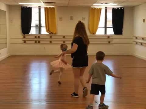 a person and two children dancing