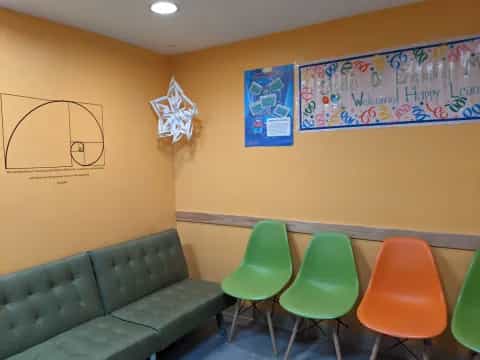 a classroom with green chairs