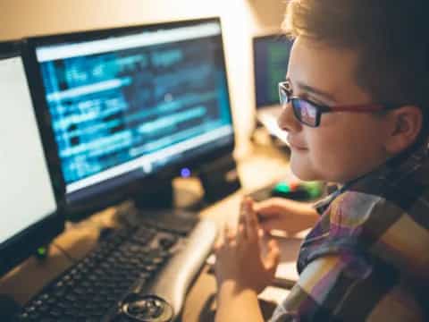 a young boy using a computer