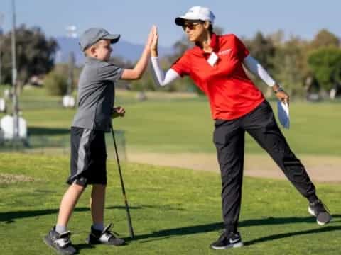 a man and a woman playing golf