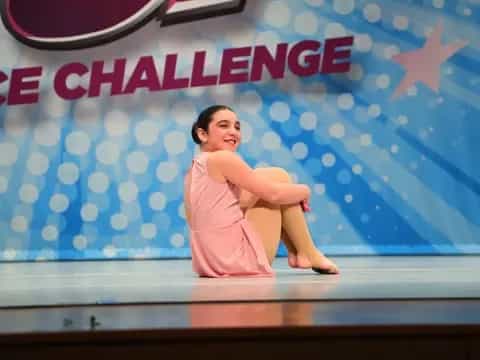 a woman sitting on a stage